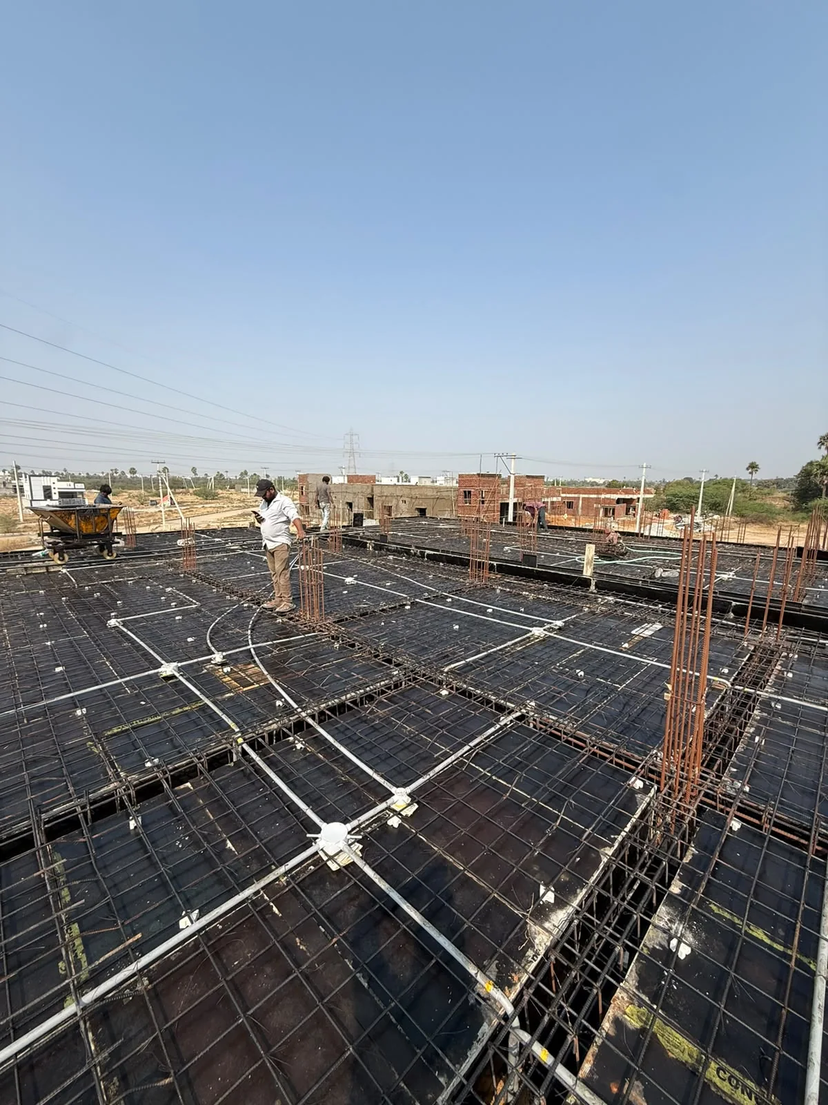 Service conduits arranged across slab reinforcement
